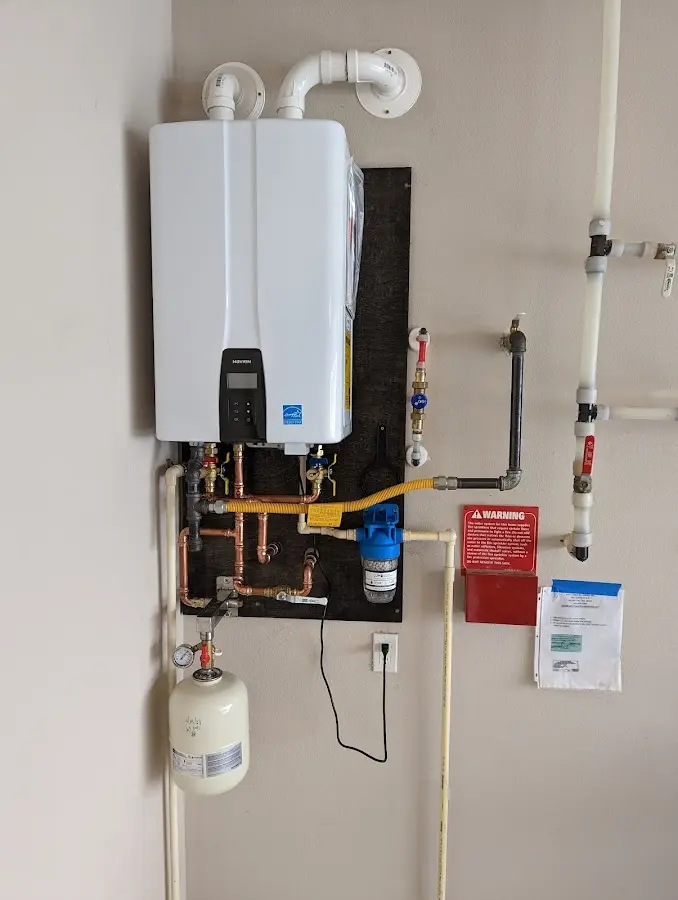 Professional plumber installing copper piping in a California home